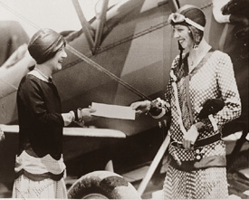 June Harrison and Olive Ann Mellor (Beech) with a Travel Air biplane, July 28, 1928